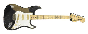 Fender Stratocaster guitar with a worn finish on a white background